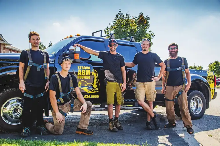 Strong Arm Roofing crew member on a residential roof