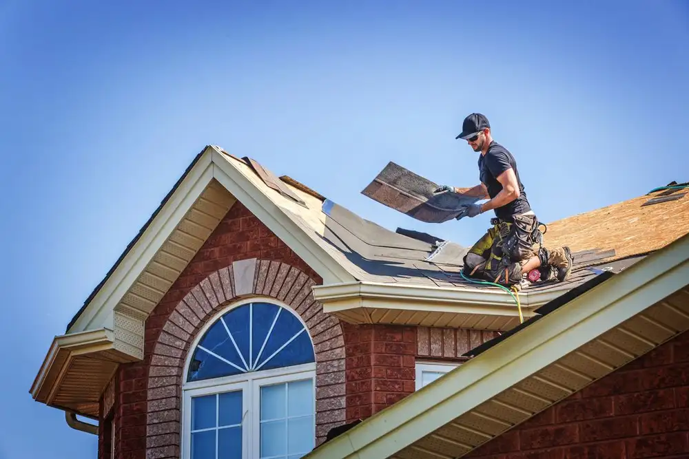 Roofing crew’s finished work on a sloped residential roof